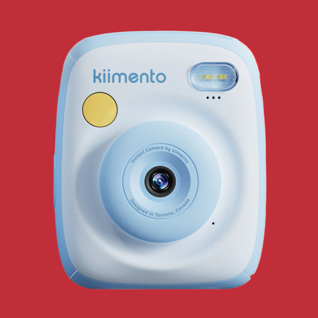 Blue and white instant camera with yellow power button on a white background